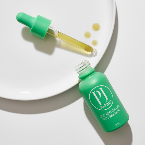 Plain Jane Full spectrum CBD oil green plastic bottle with child proof lid containing 1000 mg on a white background